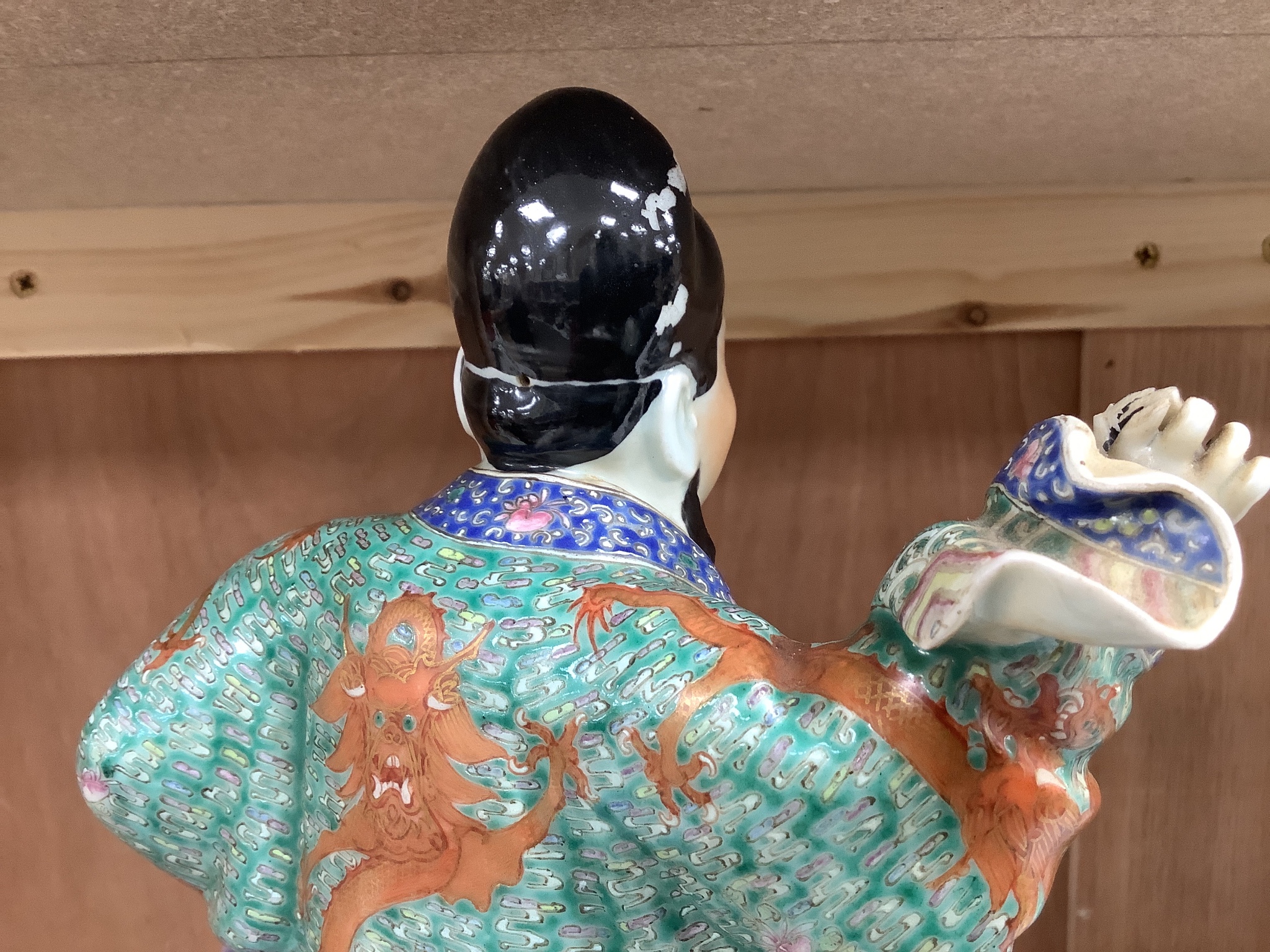 A Chinese enamelled porcelain figure group of an immortal on a mythical beast, Republic period, height 33cm